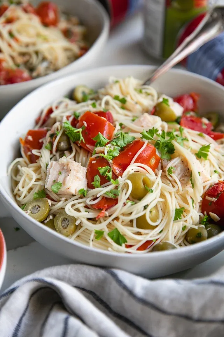 This 15-minute angel hair pasta with chicken is one of those lifesaver dinners for busy nights. Made with canned chicken, vine-ripened tomatoes, and green olives, it comes together fast without skimping on flavor. Even picky eaters tend to love it, and using pantry staples means less waste, less prep, and more time off your feet — always a win.